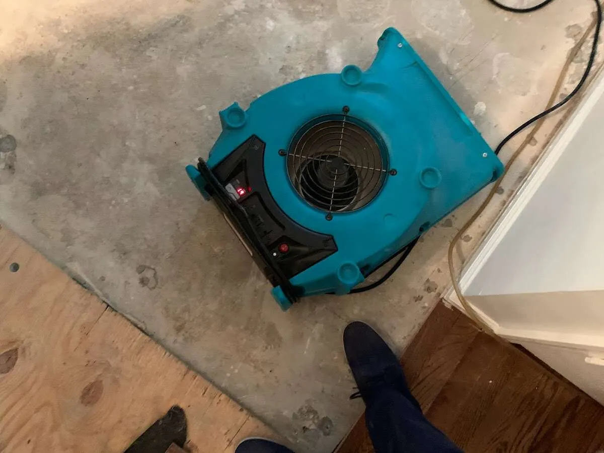 Air mover drying subfloor during Leak Detection & Repair in St. Francis